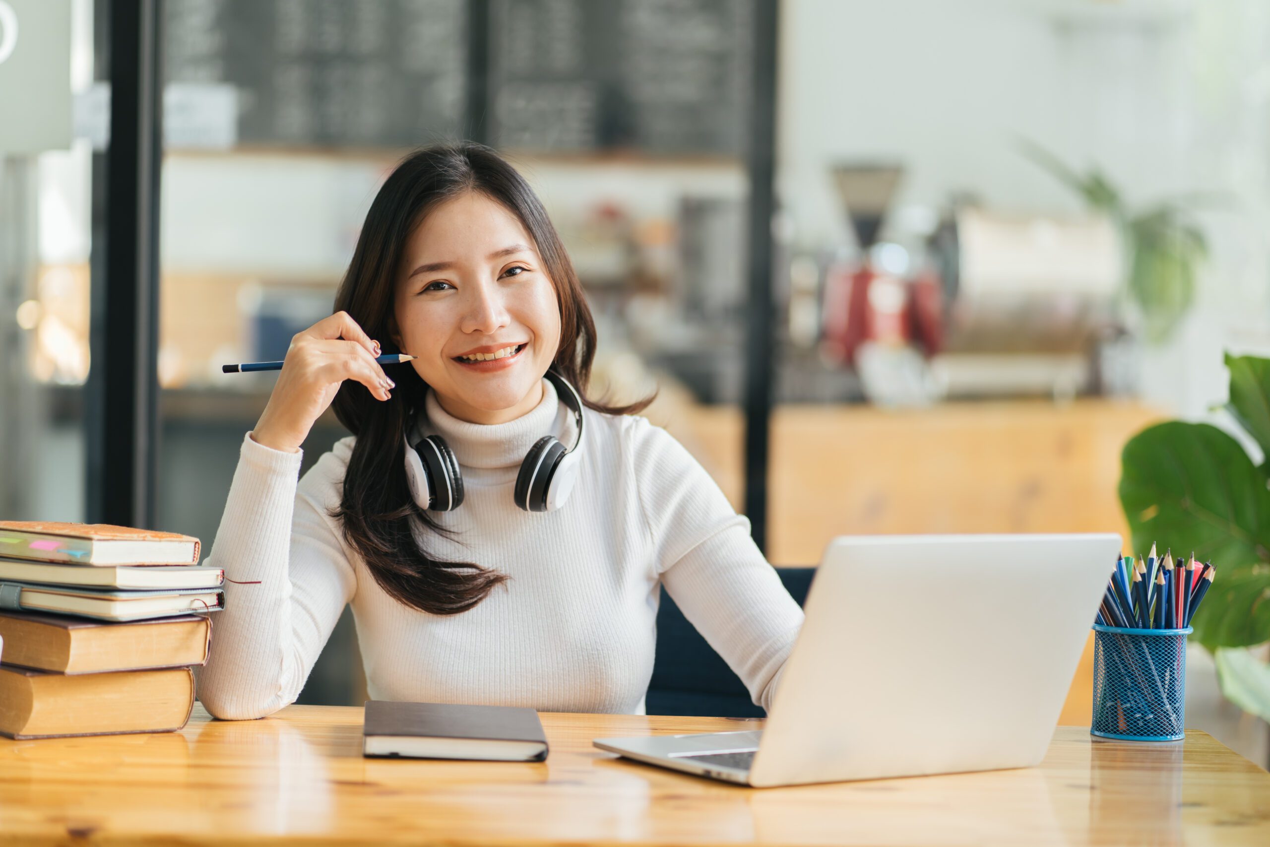 Happy young asian woman waving hand talking with remote web teac